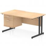 The Dynamic Pedestal Desk Impulse features a maple top with a scalloped edge and straight design. It also has a black cantilever leg for stability. This workstation includes a fixed pedestal with two drawers.