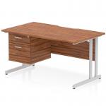 This image features a sleek and modern dynamic pedestal desk with a scalloped edge and a straight walnut top. The desk is supported by a silver cantilever leg and includes a 2 drawer fixed pedestal. The overall look is clean and functional, perfect for any office space.