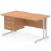 This photograph shows a stylish and versatile Dynamic Pedestal Desk, measuring 1400 x 800mm. It features a sleek oak top with a scalloped edge and is supported by silver cantilever legs. The desk also includes a convenient 3 drawer fixed pedestal for storage.