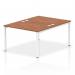 The picture features a modern office setting with a dynamic bench desking system. The spacious impulse bench has a white frame and comfortably accommodates 2 people. The surface is a stylish walnut color, creating a sleek and professional look. Perfect for any office environment.