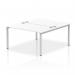 This image showcases a sleek and modern dynamic bench desking set-up. The Impulse Bench B2B 2 Person 1400 is supported by a silver frame, paired with a clean and crisp white office bench desk. Perfect for a professional and productive work environment.