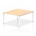 This photograph captures a sleek and modern workplace setup, featuring a dynamic bench desking system with a white frame, designed for two individuals. The maple finish on the office bench desk adds a touch of warmth to the overall design.