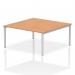 The picture shows a sleek and modern dynamic bench desk with a silver frame and smooth oak surface. It features two workstations and is designed for office use.