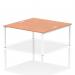 This photograph features a dynamic bench desking setup with the Impulse Bench B2B, designed for two people. The desk has a 1600 white frame, complemented by a beech top. This modern office bench is perfect for a collaborative workspace.