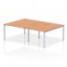 The photograph captures a modern, sleek office environment with a dynamic bench desk featuring a silver frame and oak finish. Four people can comfortably work at this 1200-size desk, making it ideal for collaborative projects.