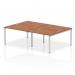 This image features a dynamic bench desking system, specifically the Impulse Bench B2B for 4 people. It has a sleek silver frame and a walnut office bench desk. The setup is ideal for a collaborative work environment.
