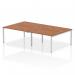 This image shows a sleek and modern dynamic bench desking setup. The Impulse Bench B2B can accommodate up to 4 people and features a silver frame and a walnut office bench desk.