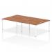 Four people sit comfortably at a modern, white-framed bench desk. The sleek design features a rich walnut top, offering a stylish and functional addition to any office space.