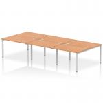 This image features a sleek and modern Dynamic Bench Desking Impulse Bench B2B that comfortably accommodates 6 people. The bench has a silver frame and is made of durable oak, providing a stylish addition to any office space.