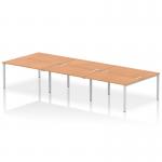 This photograph showcases a modern and sleek dynamic bench desking set up - the Impulse Bench B2B 6-Person 1400 Silver Frame Office Bench Desk with a beautiful oak finish. The bench desk is designed with efficiency and functionality in mind, perfect for any contemporary office space.