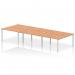 This photograph showcases a modern and sleek dynamic bench desking set up - the Impulse Bench B2B 6-Person 1400 Silver Frame Office Bench Desk with a beautiful oak finish. The bench desk is designed with efficiency and functionality in mind, perfect for any contemporary office space.