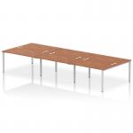 The photo captures a modern and functional work environment with the Dynamic Bench Desking Impulse Bench B2B, fitting 6 persons comfortably. The sleek silver frame contrasts beautifully with the rich walnut desk, creating a stylish and efficient workspace.