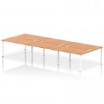 The photo shows a sleek and modern Dynamic Bench Desking Impulse Bench, specifically the B2B model for 6 people. The desk features a white frame and is made of a durable oak material.