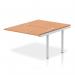 The picture showcases a sleek and modern office workspace furnished with a dynamic bench desking system. The silver frame adds a touch of elegance, while the oak desk tops bring warmth and sophistication to the setup. The open design of the impulse bench provides a spacious and collaborative work area for employees. Perfect for a professional and efficient B2B environment.
