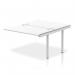 The photograph captures a sleek, modern bench desk that boasts a silver frame and white top. The dynamic design allows for flexibility and collaboration, making it a practical choice for any office setting. The spacious 1200 size provides ample workspace, while the Impulse Bench B2B Ext Kit adds an extra touch of functionality. The overall look exudes professionalism and sophistication.