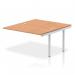 The photograph showcases a stylish and modern bench desking set-up, featuring the Dynamic Bench Impulse Bench with 1400mm B2B Ext Kit. The silver frame and oak desk surface create a professional and sleek look for any office space.