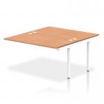 This photo showcases the sleek design of the Dynamic Bench Desking Impulse Bench B2B Ext Kit. The white frame and oak surface create a modern and clean look for any office space.