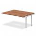 The photograph captures a sleek and modern office setup - a dynamic bench desking system with a silver frame and a walnut desk surface. The clean lines and ample workspace make it ideal for any busy office setting.