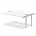 A sleek, modern bench desk with a silver frame and white top. The desk is designed for a dynamic work environment and has an extension kit for added surface space.