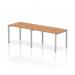 This picture features a sleek and modern dynamic bench desking setup. It showcases a single row of 2 person workstations with a silver frame and oak desk. The overall aesthetic is clean, professional, and functional.