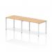 The picture shows a sleek and modern white frame office bench desk with a maple wooden top. This dynamic bench desking offers a single row for 2 people and has a clean and crisp look. Perfect for a collaborative workspace or a modern office design.