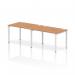 The photo shows a sleek and modern office bench desk with a white metal frame and a sleek oak tabletop. The dynamic design allows for two people to work comfortably in a single row, promoting collaboration and productivity in the workplace.