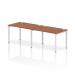 This photo features a sleek and modern office bench desk, with a white frame and a walnut surface. It is designed for two people, with a dynamic bench desking layout in a single row.