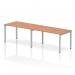 This photo captures a sleek and modern office bench desk with a silver frame and a natural beech finish. The single row design allows for two people to work comfortably side by side, promoting collaboration and efficiency. The dynamic and versatile nature of this bench desk makes it a perfect addition to any office space.