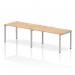 In the photo, you can see a sleek silver-framed bench desk, with a single row of two person seating. The modern design features a spacious maple top and is perfect for any office space looking for a dynamic, collaborative workspace.