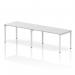 The photograph captures a sleek and modern office bench desk made up of a single row with seating for two people. The white frame adds a clean and minimalist touch to the dynamic and versatile design, making it perfect for any contemporary workspace.
