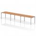 The image shows a modern, sleek bench desk with a silver frame and oak top. It can accommodate 3 people and is designed for dynamic and collaborative work environments.
