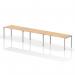 This photo shows a modern, sleek bench desk with a silver frame and maple top. The single row design accommodates 3 people, making it perfect for collaboration and productivity in any office space. The dynamic bench desking creates a contemporary and functional workspace.
