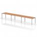 A modern and sleek silver frame holds up a sturdy oak bench desk, accommodating up to 3 people in a single row. Perfect for a dynamic and collaborative office space.