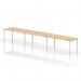 In the photograph, a sleek and modern white frame office bench desk is showcased. The dynamic bench desking design features a single row with enough space for 3 people. The desk is topped with a smooth maple surface, creating a professional and stylish workspace.