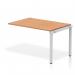 A photograph of this dynamic bench desking set up would show a row of single benches with a sleek silver frame, completed with a warm oak office bench desk. The design is modern and contemporary, perfect for any office space.