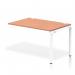 The photo shows a sleek and modern Dynamic Bench Desking Impulse Bench Single Row Ext Kit 1200 with a clean white frame and a beautiful beech desk surface. The office bench desk is perfect for a contemporary workspace, providing ample room for productivity and collaboration.