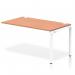 The photo shows a clean white frame with a sleek beech bench top, perfect for a modern office. The dynamic design features a single row extension kit, adding functionality to the bench desk. This setup is ideal for a collaborative work environment.