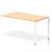 The photograph shows a dynamic bench desking setup, featuring an impulse bench with a single row extension kit in a sleek white frame. The office bench desk is finished in a warm maple color, creating a modern and functional workspace.