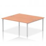 This picture features a modern and sleek Dynamic Bench Desking Impulse Bench with a silver frame and a two-person work surface. The desk is 1800mm in length and is made of beautiful beech wood. Perfect for any office setting, this desk offers a stylish and functional workspace for two individuals.