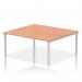 This picture features a modern and sleek Dynamic Bench Desking Impulse Bench with a silver frame and a two-person work surface. The desk is 1800mm in length and is made of beautiful beech wood. Perfect for any office setting, this desk offers a stylish and functional workspace for two individuals.