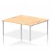 This image features a sleek and modern dynamic bench desking setup. The Impulse Bench B2B includes two spacious workstations with a 1800 silver frame for stability. The office bench desk is topped with a maple finish for a touch of warmth.