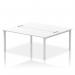 The picture shows a modern and sleek Dynamic Bench Desking Impulse Bench B2B with a silver frame and a white desk surface. The spacious 1800 design allows two people to work comfortably side by side. This office bench desk offers a dynamic and efficient workspace for any office setting.