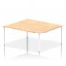 This photo showcases a dynamic bench desking setup with an Impulse Bench B2B, perfect for a team of two. The white frame and maple desk add a sleek and modern touch to any office space.