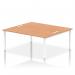 In the photo, two people are seated at a sleek and modern white bench desk. The desk has a sturdy oak top and a contemporary white frame. The dynamic design of this bench desk makes it a perfect addition to any office space.