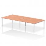 This photo features a modern and sleek Dynamic Bench Desking Impulse Bench B2B for 4 people, with a 1800 silver frame and a stylish beech desk. The simple and contemporary design would enhance any office space.