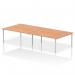 This picture features a sleek and modern office setup with a dynamic bench desking system. The Impulse Bench B2B accommodates four people and has a silver frame and an oak desk.