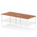 The photo shows a modern and versatile office bench desk with a white frame and a walnut top. It can accommodate four people and is designed for use in a B2B setting. The dynamic design of the bench provides a sleek and functional workspace for any office.