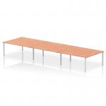 The picture shows a modern, silver-framed bench desk in an office setting. The desk has a dynamic design with 6 workstations, each featuring a sleek beech desktop. Its unique layout promotes collaboration and productivity in the workplace.