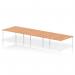 The dynamic bench desking that is Impulse Bench B2B consists of a spacious 6-person configuration with a sleek white frame and a sturdy oak desktop. This office bench desk, with its IB00421 model, appears modern and professional, perfect for any collaborative workspace.