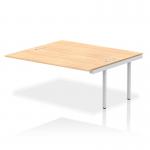 The photo shows a modern and sleek Dynamic Bench Desk with Add On Units and an extended B2B kit. The bench has a silver frame and a maple top, providing a stylish addition to any office space. The overall design is clean and functional, perfect for a professional work environment.